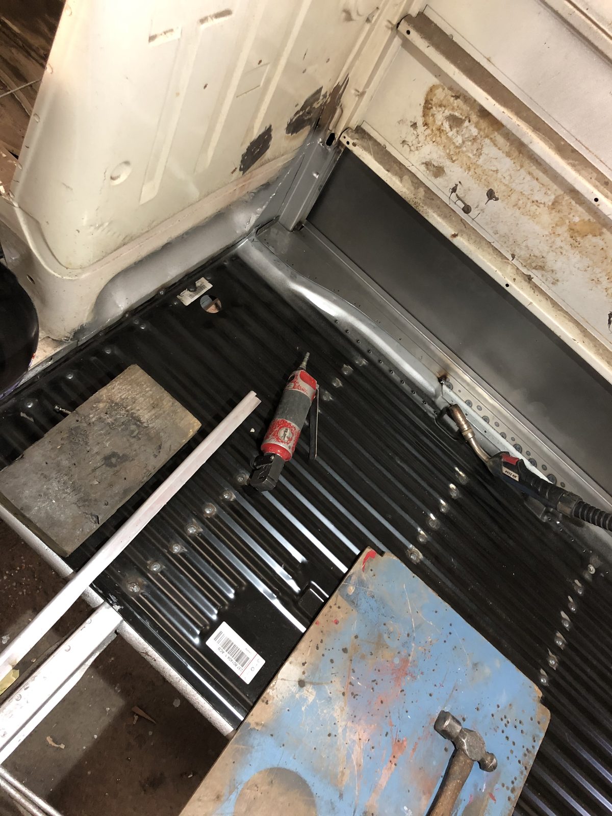 New floor pan being welded into Jenny — the cost of missing rust during inspection