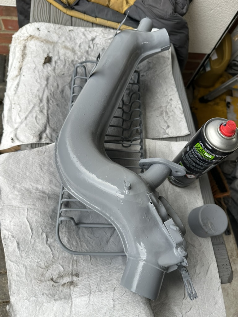 Wire brushing and priming original VW heat exchanger