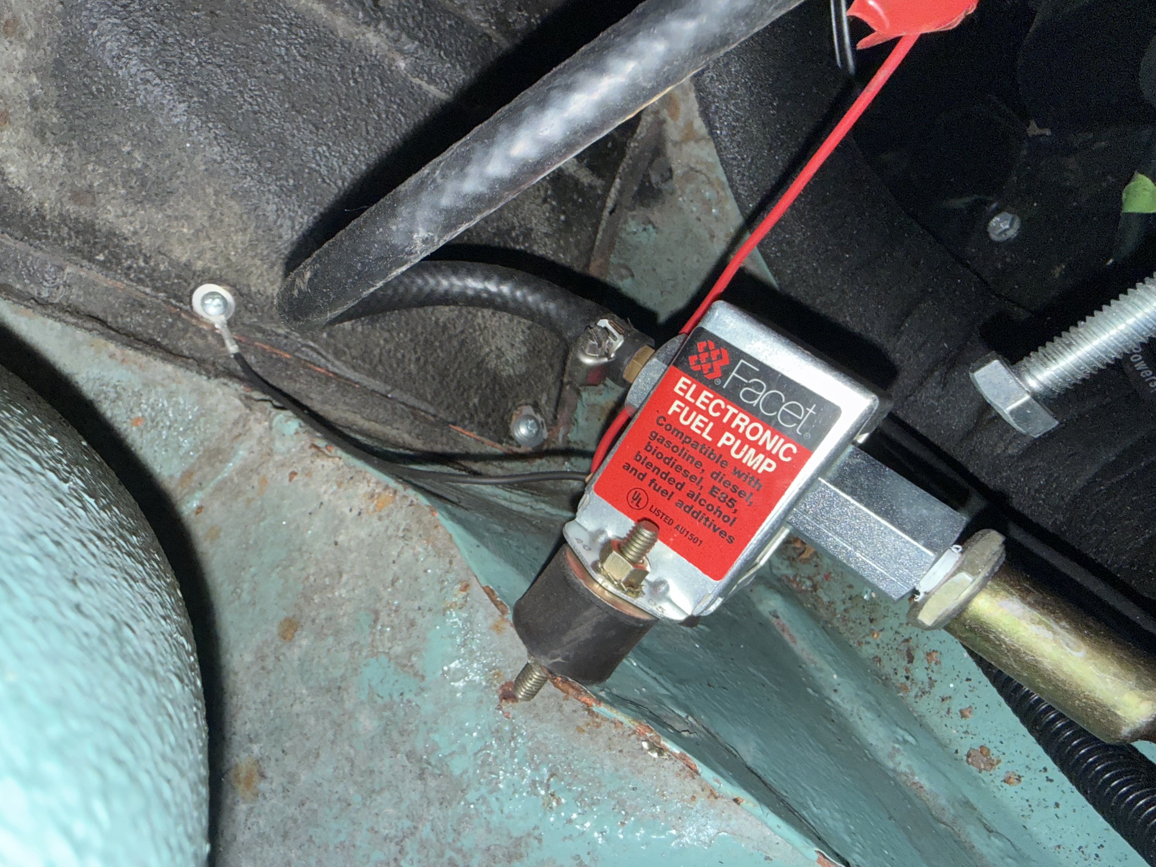 Facet fuel pump closeup detail showing solenoid and inlet/outlet ports for carburettor installation