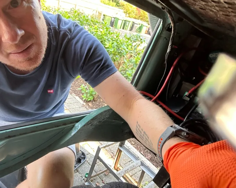Working in the VW T2 engine bay during the fuel pump installation