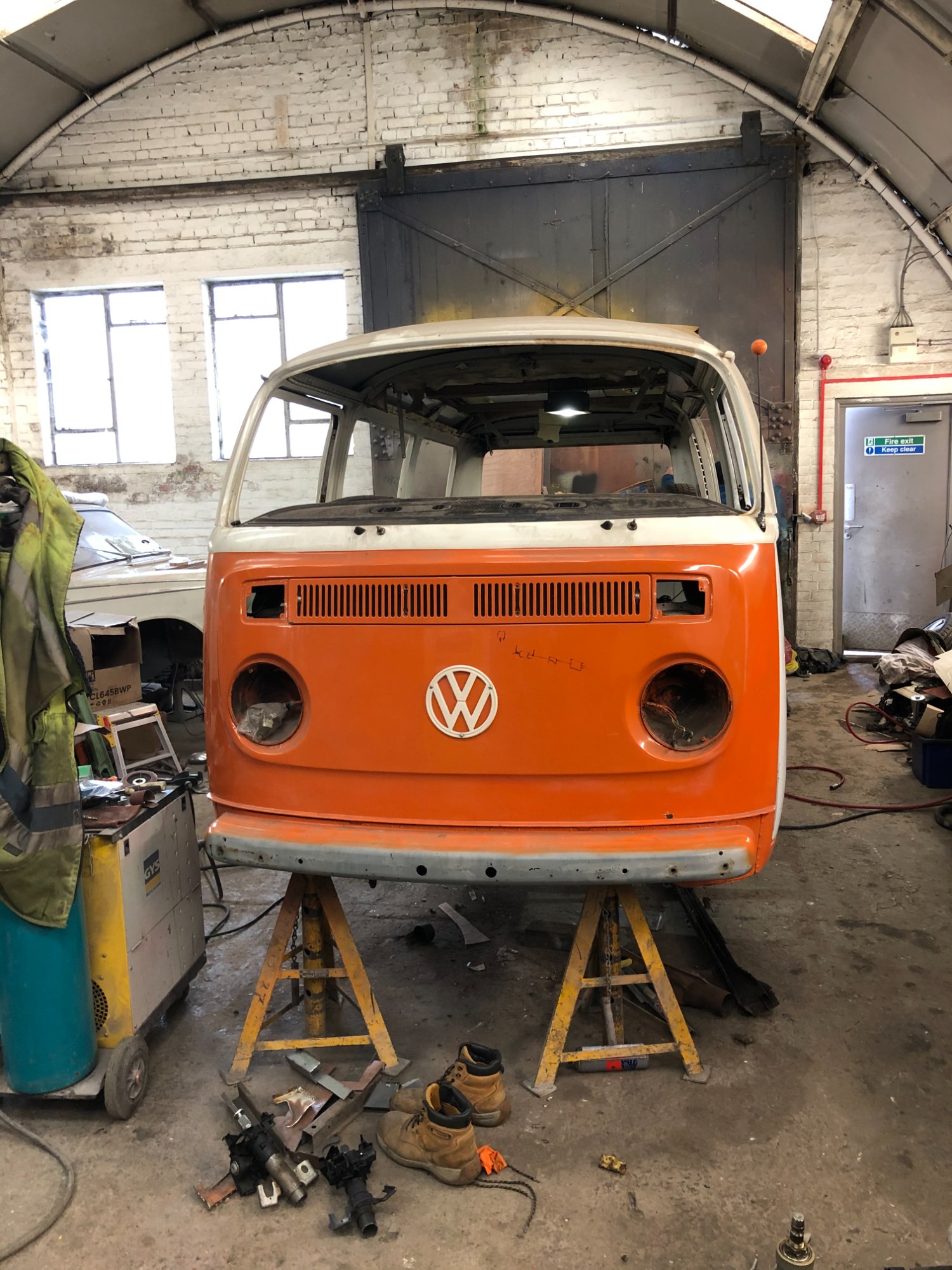 Jenny on stands in workshop with orange front