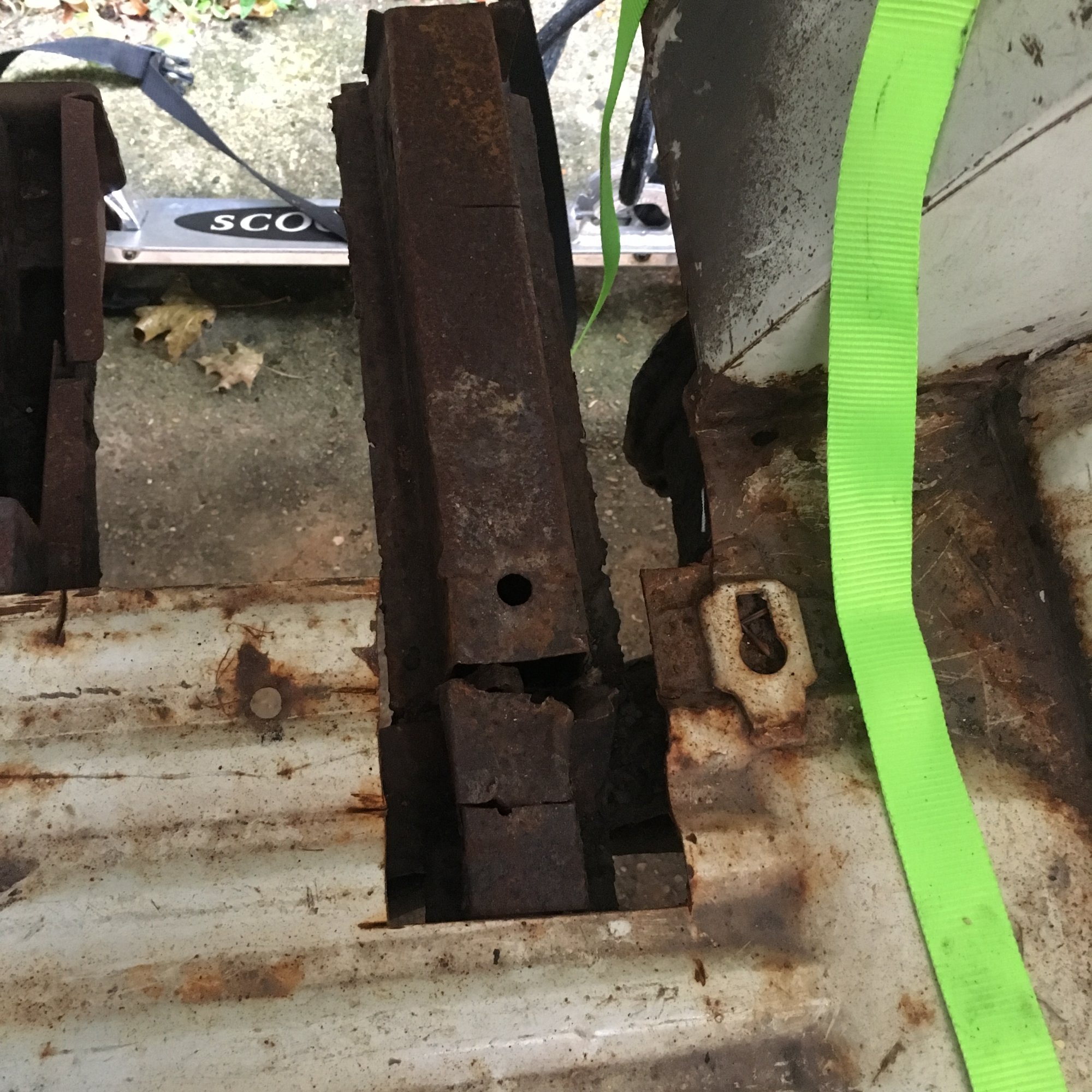 Holes in Jenny's floor showing rusty chassis