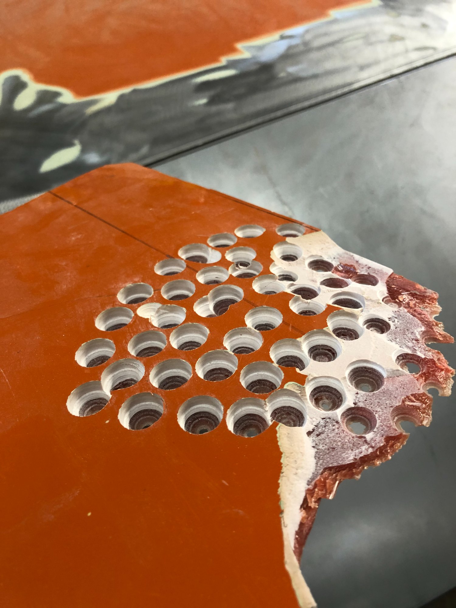 Deep filler exposed under orange paint