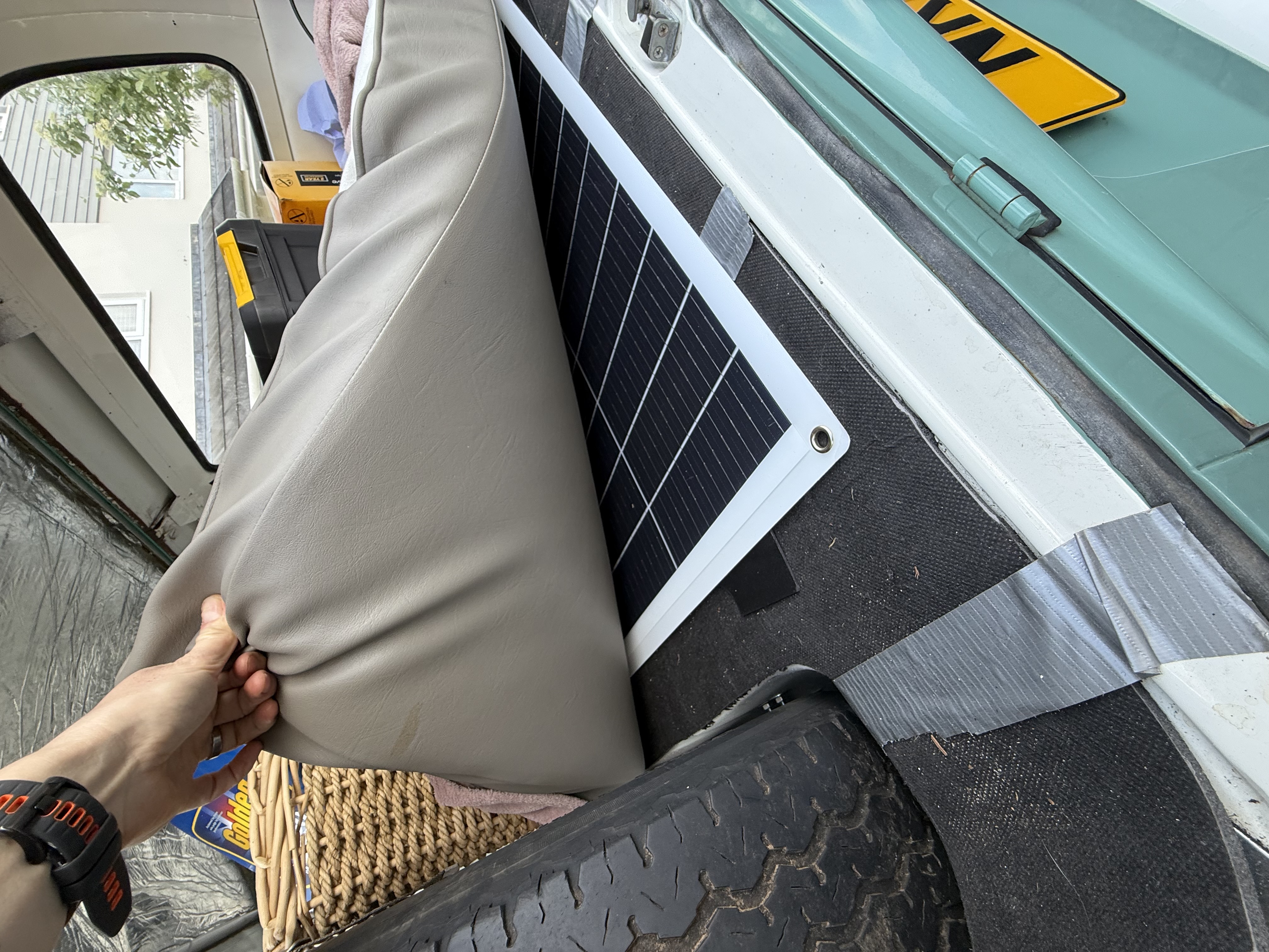 Complete solar power system setup in VW T2 Bay Window campervan showing panel, charge controller, battery connections and installation